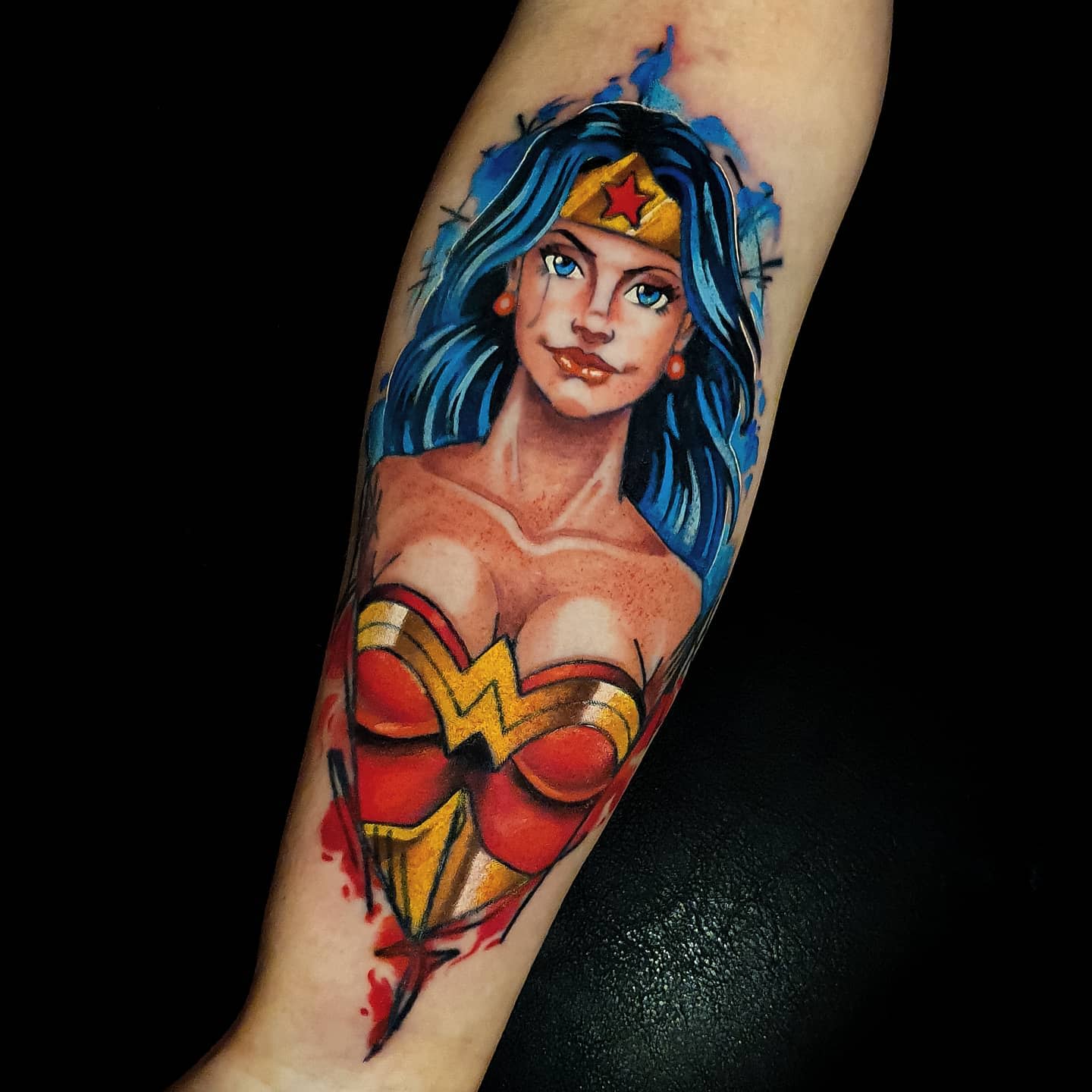 Vibrant tattoo of Wonder Woman in bold colors and new school style, showcasing her strong expression